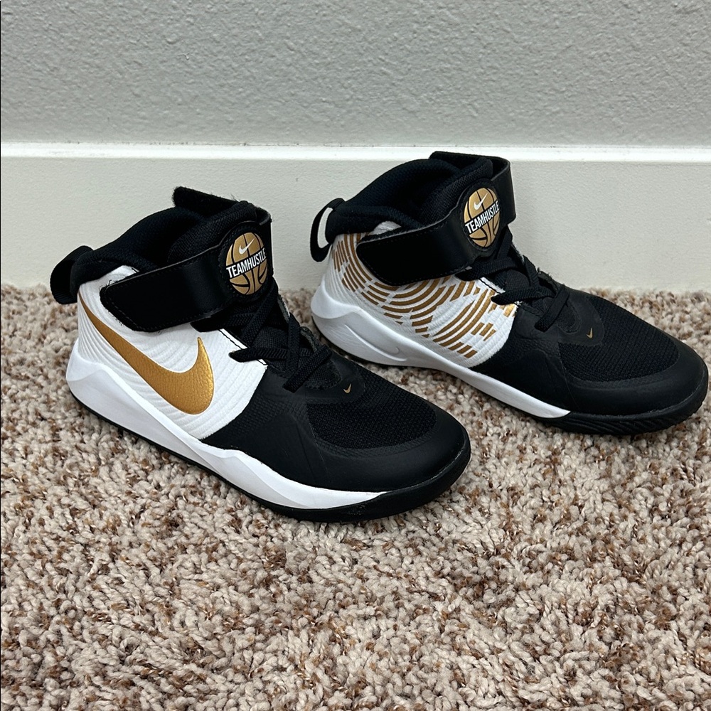 Nike Black and Gold Team Hustle shoes, size 1.5Y